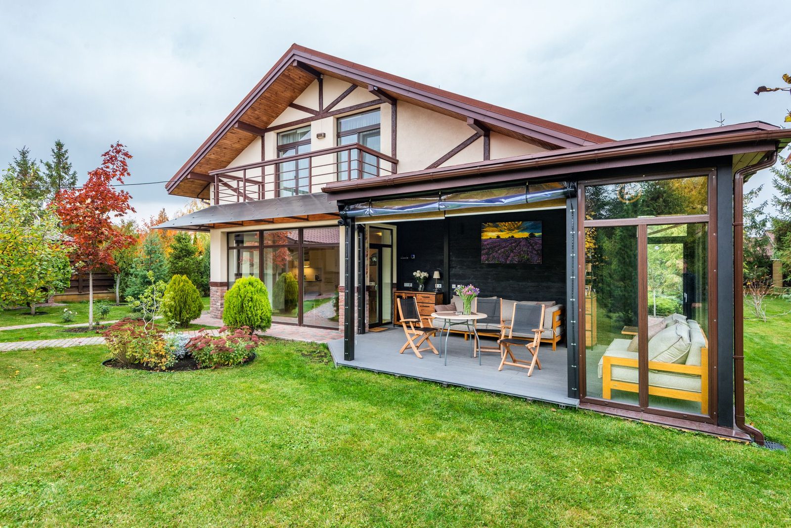 Modern lean-to style glass extension along the back of a house
